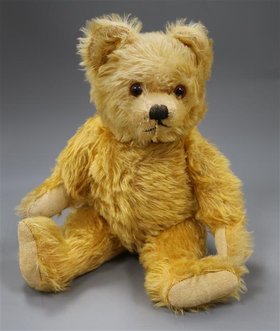 A 1930s Farnell teddy bear, Carol / Carrie, with golden mohair, deep amber and black glass eyes, pronounced